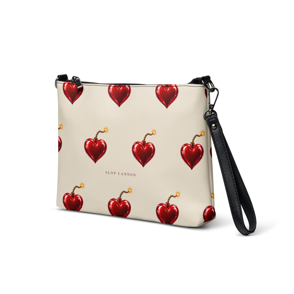 Slop Cannon Heart Fuse Crossbody Bag — Cream / black trim — three-quarter front view; bag only; printed faux leather with black trim; supplier digital mockup.