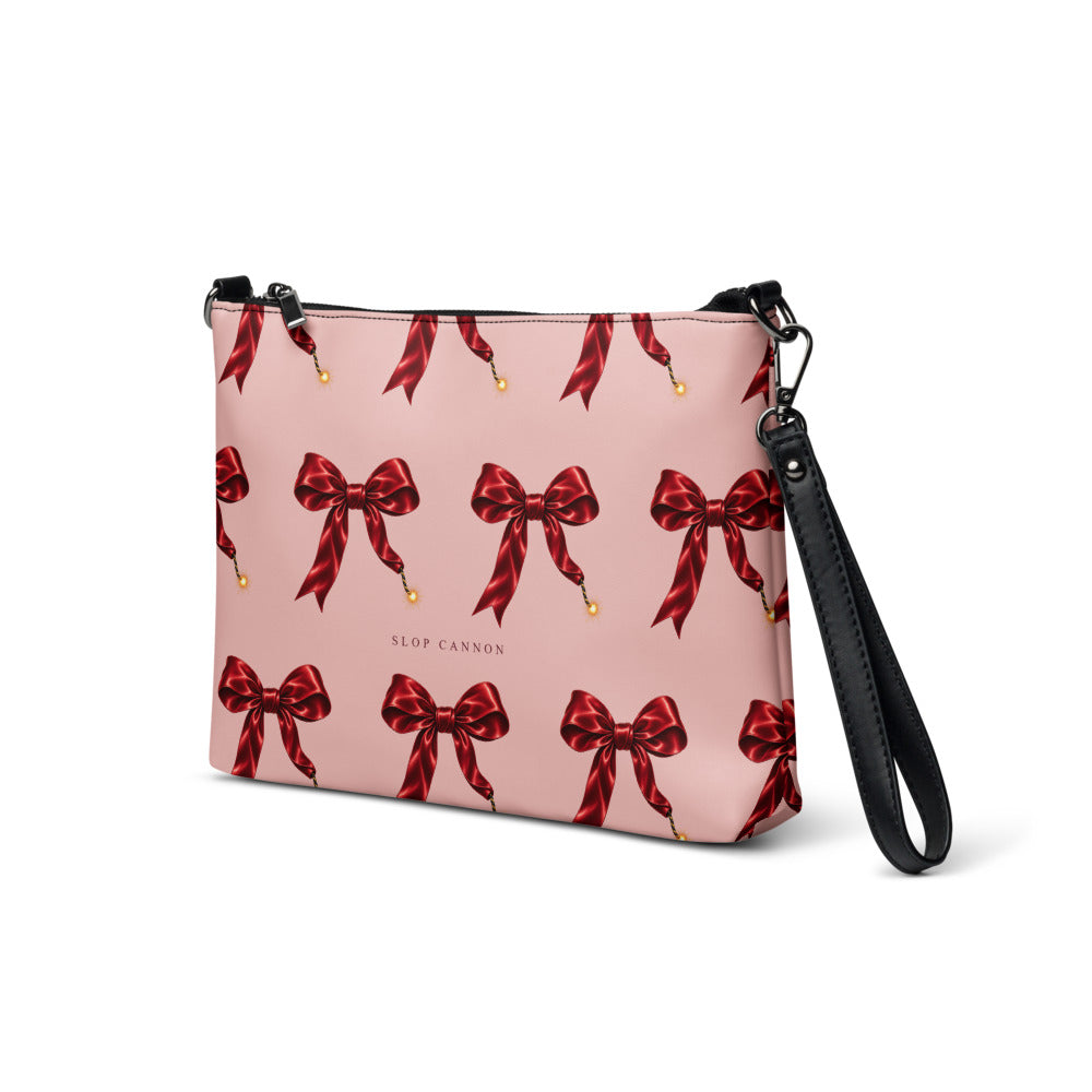 Slop Cannon Short Fuse Crossbody Bag — Blush / black trim — three-quarter front view; bag only; printed faux leather with black trim; supplier digital mockup.
