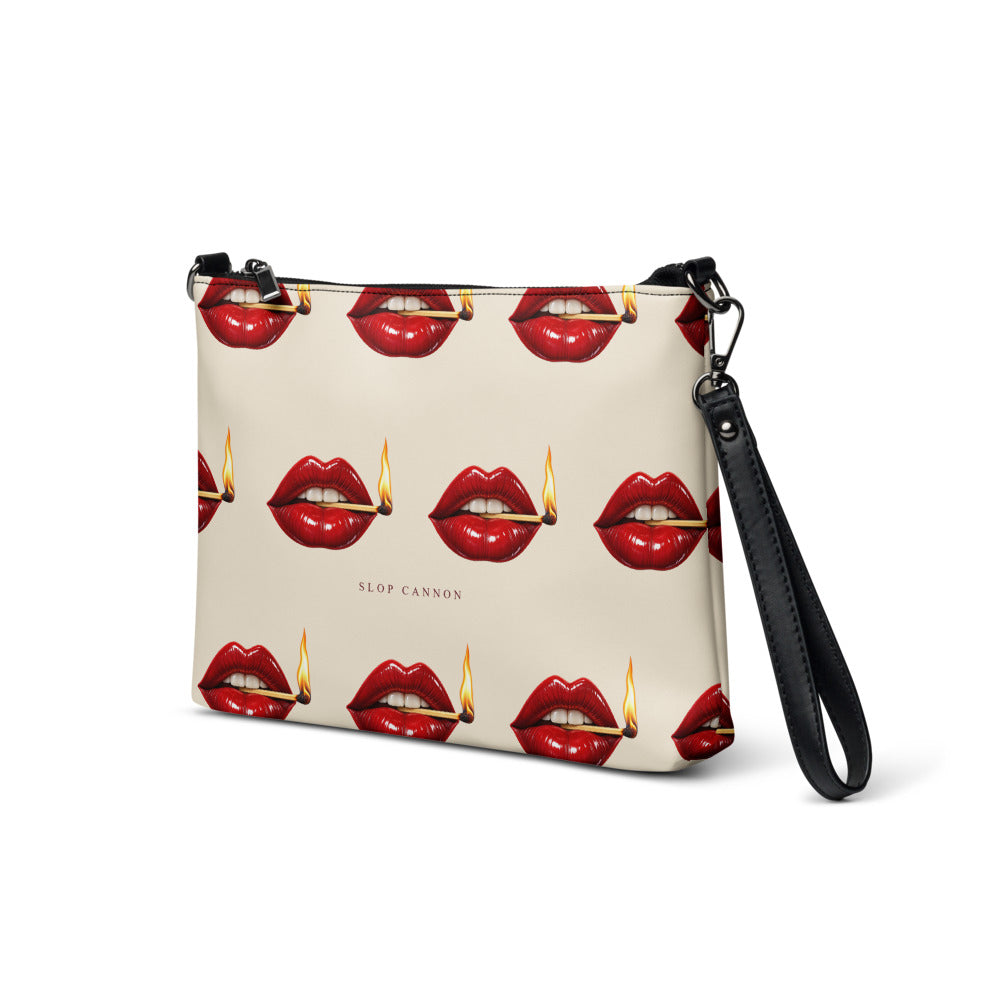 Slop Cannon Play With Fire Crossbody Bag — Cream / black trim — three-quarter front view; bag only; printed faux leather with black trim; supplier digital mockup.