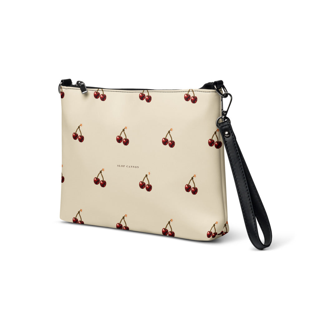 Slop Cannon Cherry Fuse Repeat Crossbody Bag — Cream / black trim — three-quarter front view; bag only; printed faux leather with black trim; supplier digital mockup.