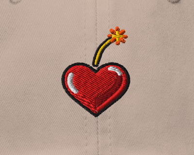 Heart Fuse — Stone — embroidery artwork detail cropped from supplier digital preview; simulated thread texture; Yupoong 6245CM Stone; supplier digital mockup.