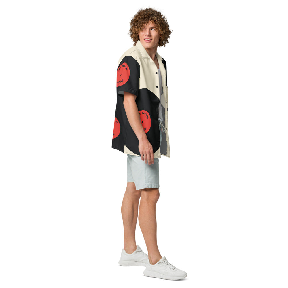 Slop Cannon Records Beach Button-Up — Cream / Black / Red — three-quarter model view with configured printed sleeve; shirt only; Printful all-over-print unisex button-up shirt White base / all-over print; supplier digital mockup.
