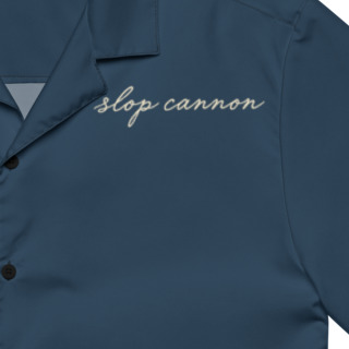 Cannon Coast Beach Button-Up — Navy / Cream — printed chest signature detail cropped from supplier digital mockup; Printful all-over-print unisex button-up shirt Navy and cream all-over print; supplier digital mockup.
