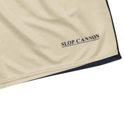 Cannon Boys mesh shorts — Bone (printed) — wearer-left leg underlined SLOP CANNON detail cropped from supplier digital mockup; Printful all-over-print recycled unisex mesh shorts White base with printed Bone (printed); supplier digital mockup.