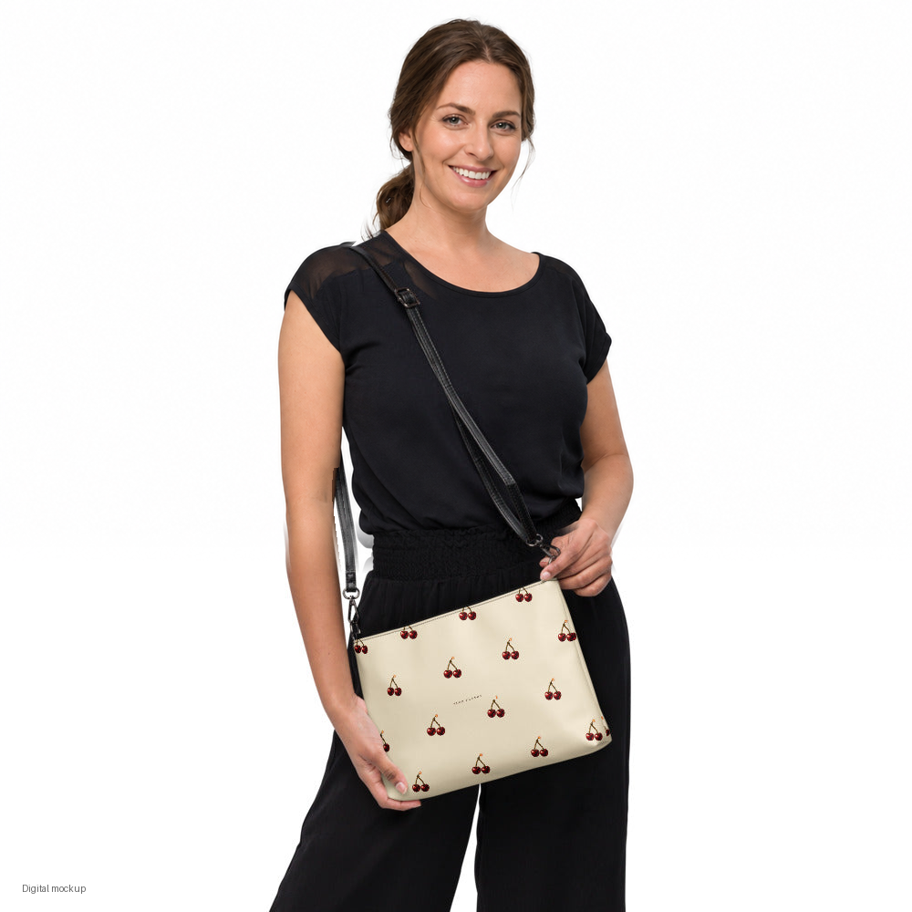 Slop Cannon Cherry Fuse Repeat Crossbody Bag — Cream / black trim — model-worn front view; bag only; styling clothing excluded; printed faux leather with black trim; digital model composite with exact supplier bag, strap and print pixels. Not a manufactured sample photograph.