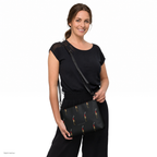 Slop Cannon Loaded Crossbody Bag — Black / black trim — model-worn front view; bag only; styling clothing excluded; printed faux leather with black trim; digital model composite with exact supplier bag, strap and print pixels. Not a manufactured sample photograph.
