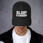 Slop Cannon Heavy Block Trucker Hat — Black / Black / White — adult model wearing the hat; supplier digital mockup; hat only, outfit shown for styling